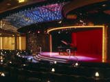 Galaxy Lounge - The main showroom for Crystals award-winning Broadway-style production shows and headline entertainers features exceptionally comfortable seating and a hydraulic-rising stage for optimum viewing From anywhere in the room. In addition to the sophisticated staging, the acclaimed shows each feature elaborate costumes and sets created by renowned designers with decades of theatrical experience. - Deluxe Cruises 2024-2025-2026-2027